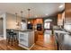 Kitchen with breakfast bar, stainless appliances, wood cabinets, and hardwood floors at 1430 Bluefield Ave, Longmont, CO 80504