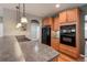 Bright kitchen with stainless steel appliances, wood cabinets, and hardwood flooring at 1430 Bluefield Ave, Longmont, CO 80504