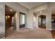 Neutral living room showcasing a decorative arched entryway, built-in shelving, and carpet and hardwood flooring at 1430 Bluefield Ave, Longmont, CO 80504