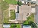 A bird's-eye view reveals a home with a well-maintained lawn, patio, gardens, and driveway at 1973 Bahama St, Aurora, CO 80011