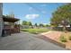 Large backyard with grass area and mature trees, and a stone patio at 1973 Bahama St, Aurora, CO 80011