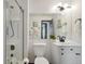 Modern bathroom with white vanity, a large mirror and glass enclosed shower at 1973 Bahama St, Aurora, CO 80011