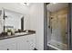 Bathroom featuring a vanity with a stone countertop, and an adjacent walk-in shower at 1973 Bahama St, Aurora, CO 80011