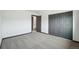 Bedroom featuring gray closet doors, carpet, and fresh white paint at 1973 Bahama St, Aurora, CO 80011