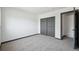 Bedroom with closet doors and access to an adjacent room at 1973 Bahama St, Aurora, CO 80011