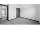 Carpeted bedroom with a closet and connection to an adjacent room at 1973 Bahama St, Aurora, CO 80011