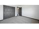 Bright bedroom featuring neutral carpeting and gray closet doors at 1973 Bahama St, Aurora, CO 80011
