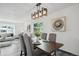 Elegant dining room featuring a rustic wood table, stylish light fixture, and gray laminate floors at 1973 Bahama St, Aurora, CO 80011