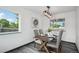 Elegant dining room featuring a rustic wood table, stylish light fixture, and gray laminate floors at 1973 Bahama St, Aurora, CO 80011