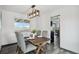 Cozy dining area features wood table, stylish light fixture, and views into the kitchen at 1973 Bahama St, Aurora, CO 80011