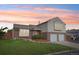 Charming two-story home with brick accents, a well-manicured lawn, and an attached two-car garage at 1973 Bahama St, Aurora, CO 80011