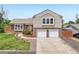 Charming two-story home features a two-car garage, brick accents, and well-maintained landscaping at 1973 Bahama St, Aurora, CO 80011