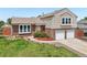Charming two-story home features a two-car garage, brick accents, and well-maintained landscaping at 1973 Bahama St, Aurora, CO 80011