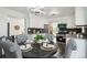 Bright kitchen with white cabinetry, stainless appliances, and an adjacent dining area for easy meals at 1973 Bahama St, Aurora, CO 80011