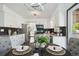 The open-concept kitchen features white cabinets, stainless steel appliances, and a modern backsplash for style at 1973 Bahama St, Aurora, CO 80011