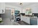 This updated kitchen features stainless steel appliances, white cabinets, and a modern backsplash for style at 1973 Bahama St, Aurora, CO 80011
