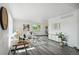Bright living room boasts large windows, neutral decor, and wood laminate flooring at 1973 Bahama St, Aurora, CO 80011