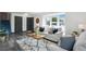 Bright living room boasts large windows, neutral decor, and wood laminate flooring at 1973 Bahama St, Aurora, CO 80011