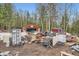 View of a garage with a basketball hoop surrounded by discarded furniture and debris at 1645 Little Bear Creek Rd, Idaho Springs, CO 80452
