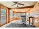Sunroom with wood paneled walls, ceiling fan, and washer/dryer hookups at 1645 Little Bear Creek Rd, Idaho Springs, CO 80452