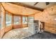 Sunroom featuring wood paneled walls, large windows, and washer/dryer hookups at 1645 Little Bear Creek Rd, Idaho Springs, CO 80452