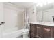 Well-maintained bathroom featuring a vanity with sink, toilet, and tiled shower and tub combo at 14454 E Colorado Dr # 103, Aurora, CO 80012