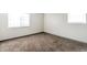 Comfortable bedroom with neutral carpet, two windows for natural light, and baseboard trim at 14454 E Colorado Dr # 103, Aurora, CO 80012