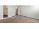 Neutral bedroom with carpet, baseboard trim, and access to an en-suite bathroom and walk-in closet at 14454 E Colorado Dr # 103, Aurora, CO 80012