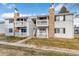 Inviting two-story condo with stone accents and a cozy, covered balcony for relaxing outdoors at 14454 E Colorado Dr # 103, Aurora, CO 80012