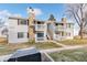 Beautiful two-story condo building with stone detailing, private balconies, and serene outdoor space at 14454 E Colorado Dr # 103, Aurora, CO 80012