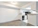 Compact kitchen with white cabinets and black appliances, seamlessly connecting to the adjacent dining area at 14454 E Colorado Dr # 103, Aurora, CO 80012
