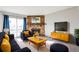 Stylish living room with a stone fireplace, modern furniture, and bright decor for comfortable living at 14454 E Colorado Dr # 103, Aurora, CO 80012
