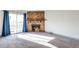Cozy living room with a stone fireplace, sliding door, and plush carpet for comfortable living at 14454 E Colorado Dr # 103, Aurora, CO 80012