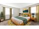 Beautifully staged main bedroom with natural light and stylish decor and modern furniture at 14454 E Colorado Dr # 103, Aurora, CO 80012