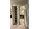 View of the bathroom with dark vanity and a closet with shelves; opens to the kitchen at 100 E Highline Cir # 105, Centennial, CO 80122