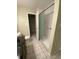 Bathroom featuring white tile flooring, shower with sliding glass doors, toilet, and closet at 100 E Highline Cir # 105, Centennial, CO 80122