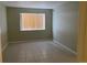 An empty bedroom that has tile flooring, a window with blinds, and olive-green walls at 100 E Highline Cir # 105, Centennial, CO 80122