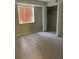 Bright bedroom with tile flooring, a closet, and ample natural light from a large window at 100 E Highline Cir # 105, Centennial, CO 80122