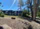 Scenic view of a multi-story apartment building surrounded by trees and greenery at 100 E Highline Cir # 105, Centennial, CO 80122