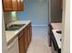 Well-lit kitchen featuring wood cabinets, stainless steel appliances, and tile flooring at 100 E Highline Cir # 105, Centennial, CO 80122