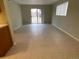 Bright living room with sliding glass doors and tile flooring, adjacent to the kitchen at 100 E Highline Cir # 105, Centennial, CO 80122