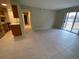 Bright living room with sliding glass doors and tile flooring, adjacent to the open kitchen at 100 E Highline Cir # 105, Centennial, CO 80122