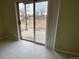 View of the sliding glass doors leading to the patio, flooding the room with natural light at 100 E Highline Cir # 105, Centennial, CO 80122