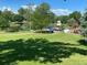 Community park featuring a playground, pond, grassy area, trees, and picnic shelter at 100 E Highline Cir # 105, Centennial, CO 80122