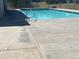 Community pool area with inground pool, concrete deck, and metal hand rail at 100 E Highline Cir # 105, Centennial, CO 80122