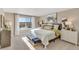 Main bedroom with large window and plush bedding at 847 Ledge St, Lochbuie, CO 80603