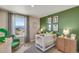 Bedroom with crib and calming decor, and a view at 847 Ledge St, Lochbuie, CO 80603