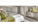Bright bedroom with plush bedding and large window at 847 Ledge St, Lochbuie, CO 80603