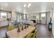 Kitchen and dining area with light wood table and green chairs at 847 Ledge St, Lochbuie, CO 80603