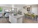 Open concept kitchen with island and dining area view at 847 Ledge St, Lochbuie, CO 80603
